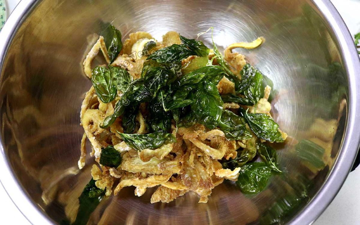 Tossing crispy oyster mushrooms with fried basil