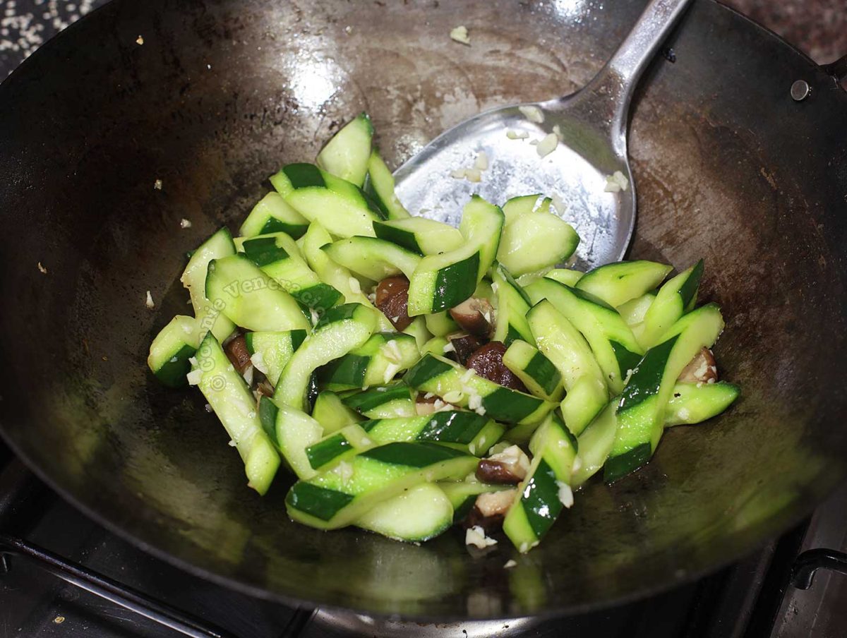 Cucumber and mushroom stir fry in wok