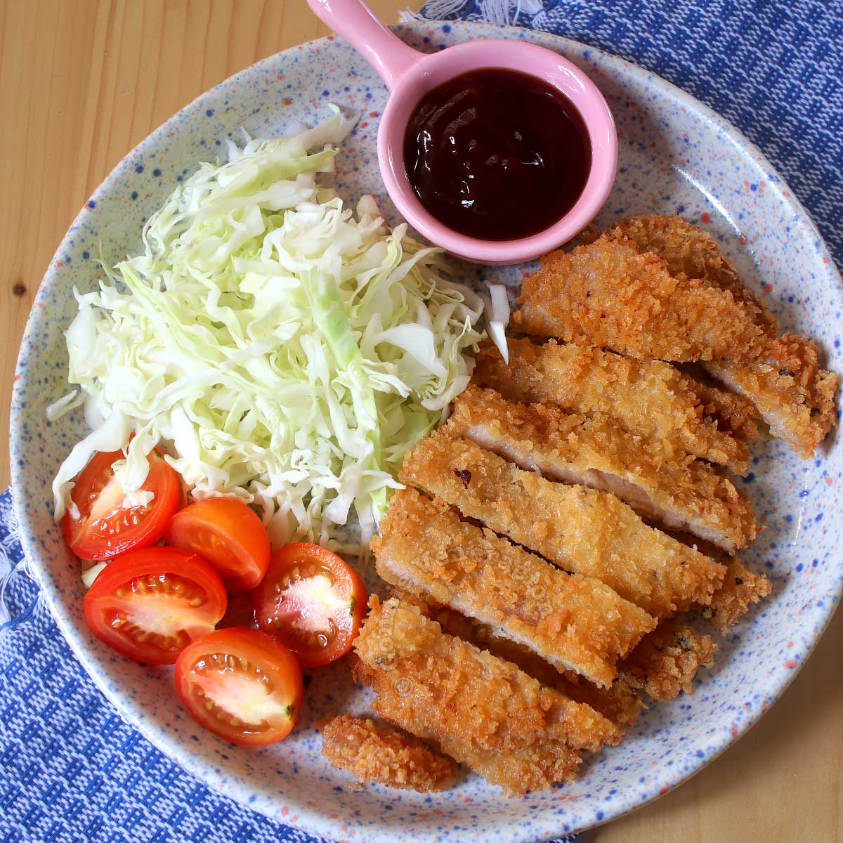 Tonkatsu (Japanese fried pork cutlet) with sauce and shredded cabbage