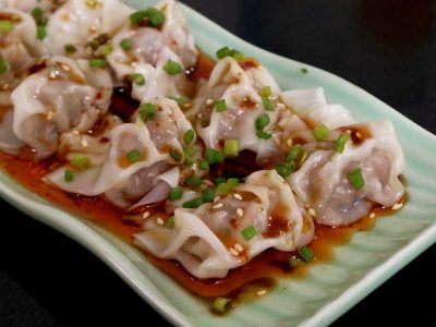 Wontons in Sichuan Chili Oil Sprinkled with Scallions and Sesame Seeds