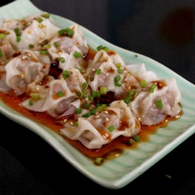 Wontons in Sichuan Chili Oil Sprinkled with Scallions and Sesame Seeds