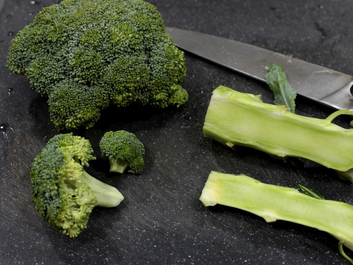 Broccoli stem and florets on chopping board