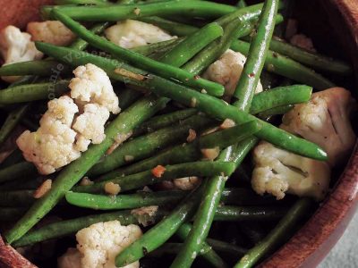 Green Beans and Cauliflower With Herb and Spice Butter in Wooden Bowl