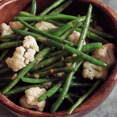 Green Beans and Cauliflower With Herb and Spice Butter in Wooden Bowl