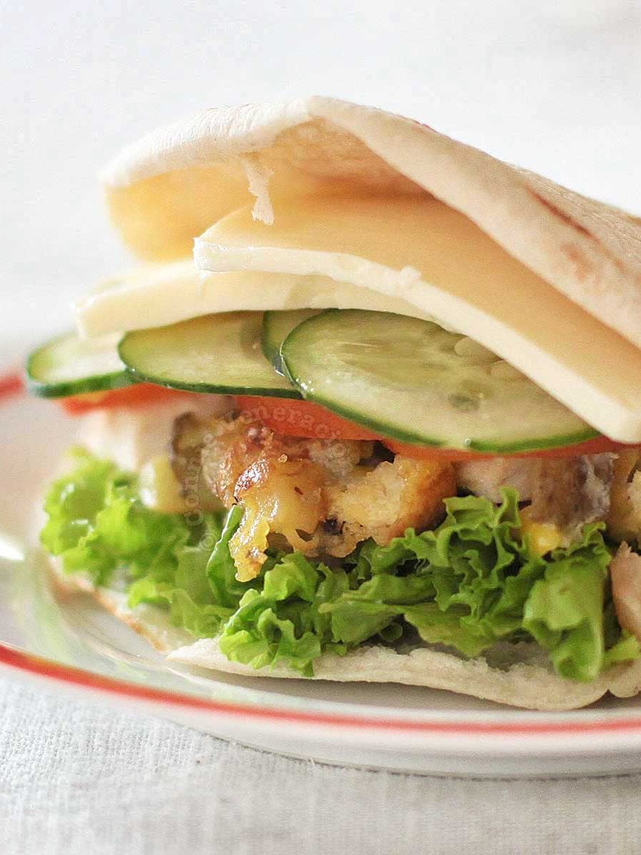 Pita pocket stuffed with chicken, eggs, vegetables and cheese