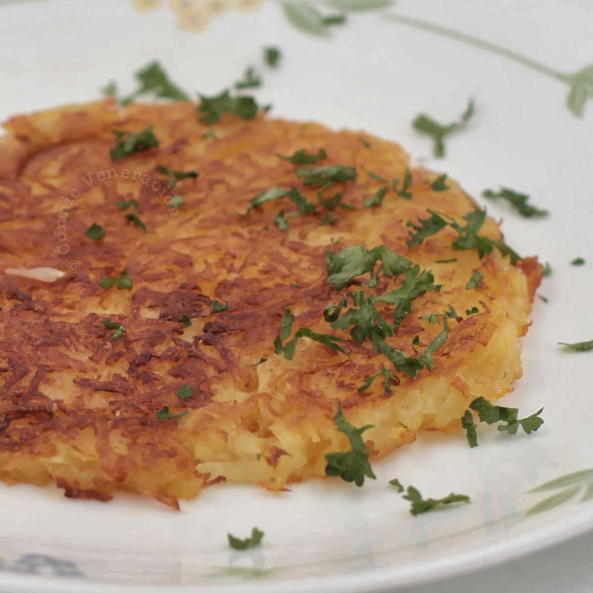 Rosti (Swiss fried grated potatoes) garnished with parsley
