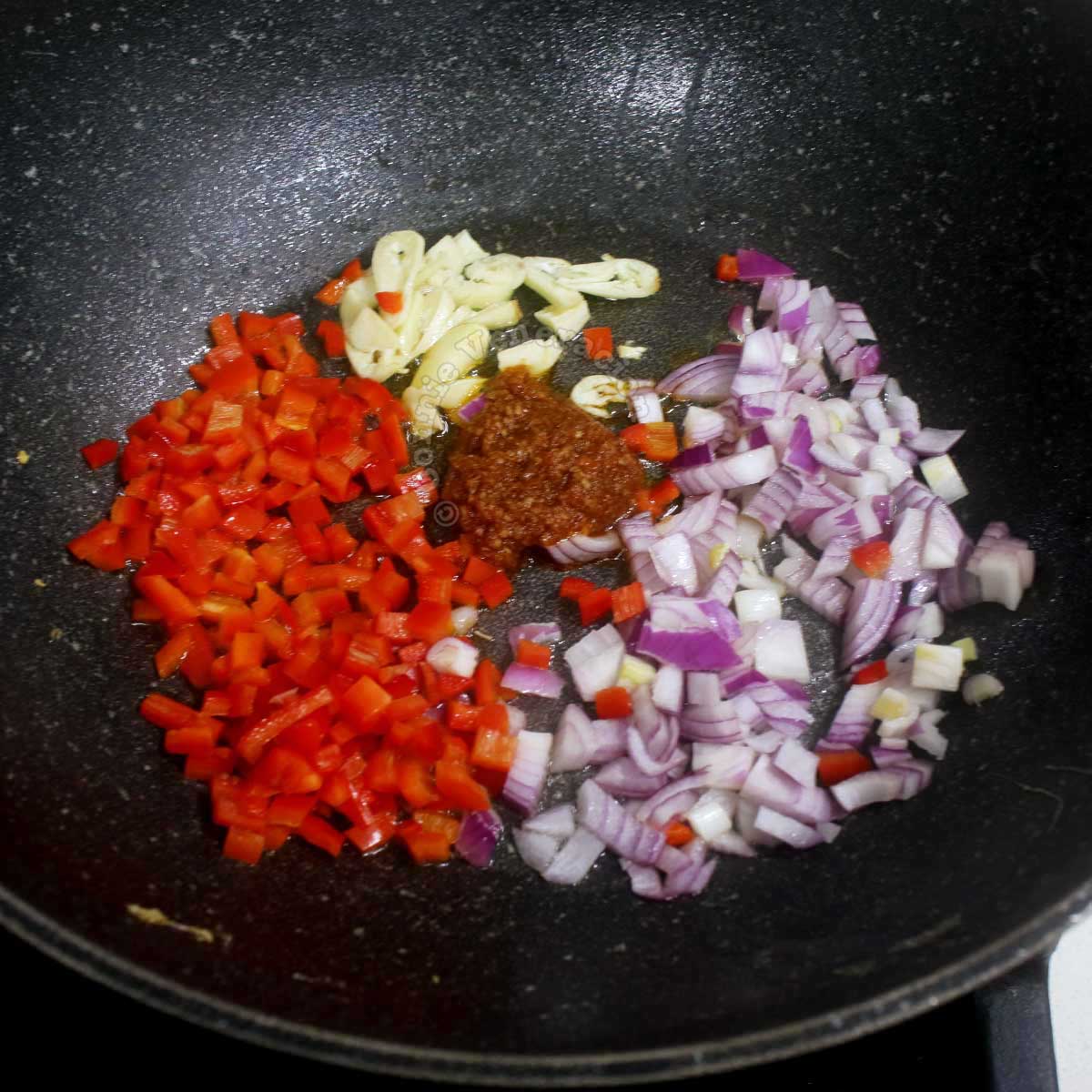 Sauteeing garlic, shallot, bell pepper and shrimp paste