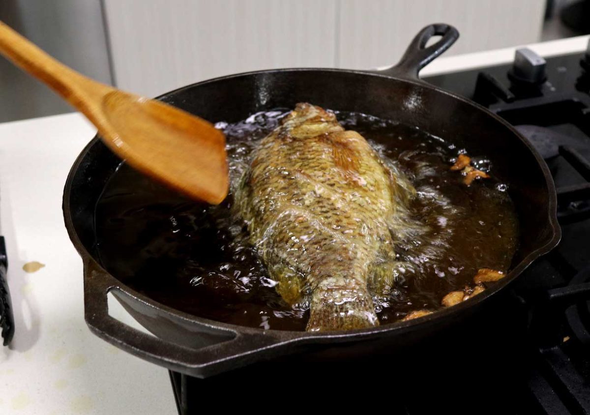 Deep frying a whole tilapia in cast iron pan