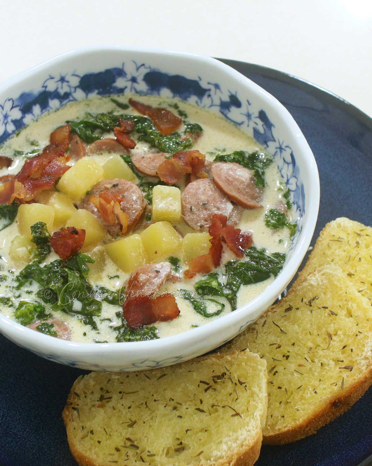 Kale, sausage and potato soup (zuppa Toscana) with buttered toast on the side