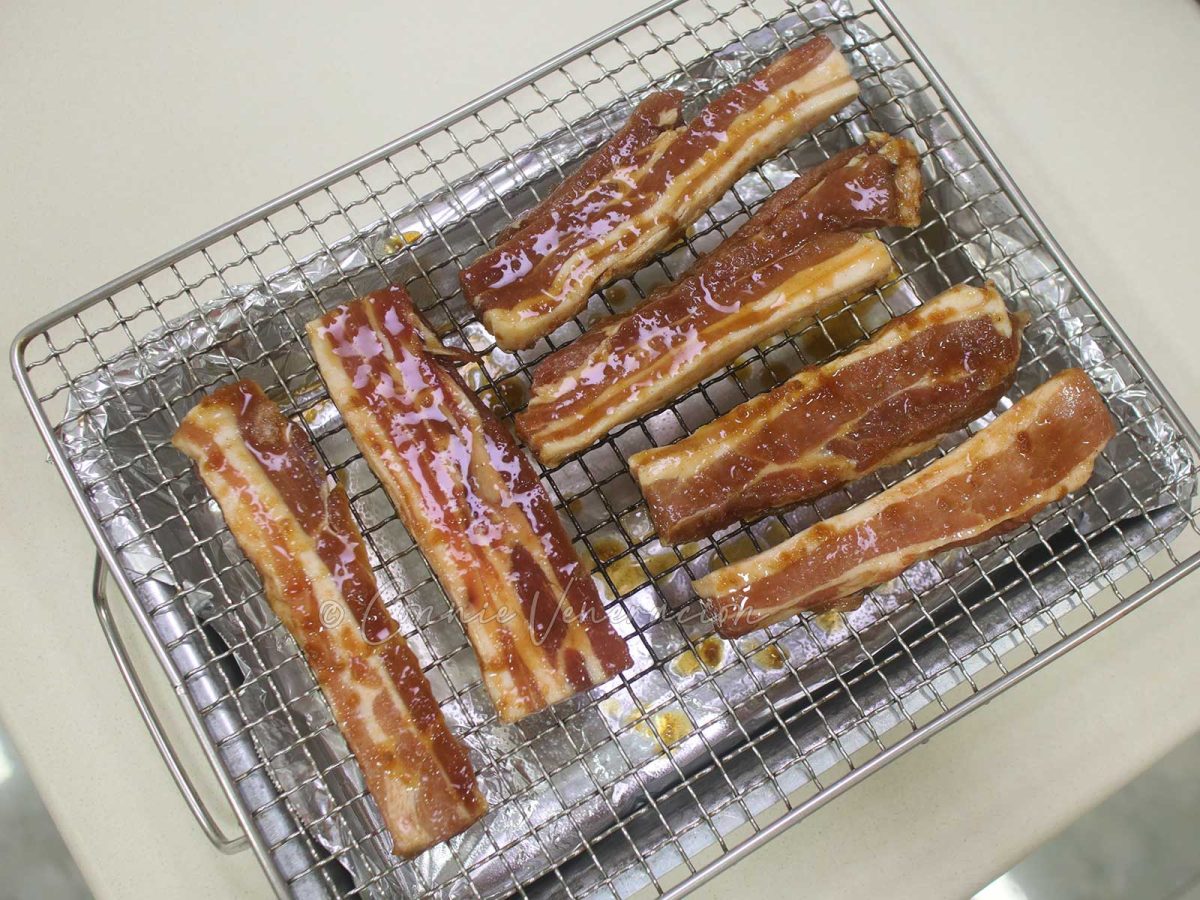 Marinated pork on rack set over tray lined with foil