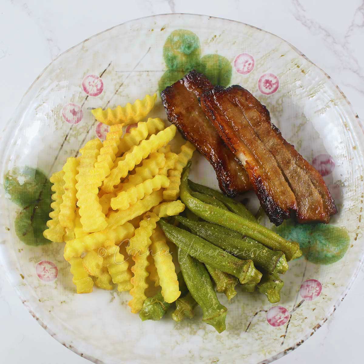 Steamed okra, fries and pork bulgogi on plate