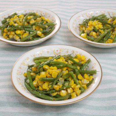 Garlic butter corn and green beans in Noritake bowls