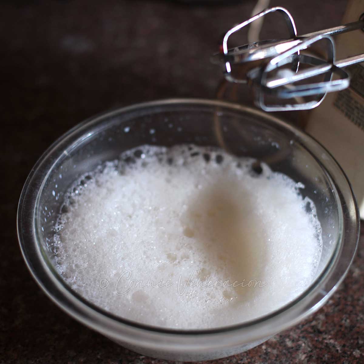 Whipping hot milk to create froth