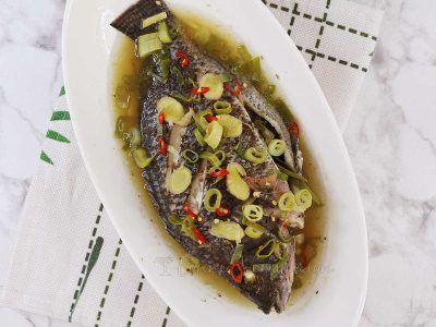 Steamed whole tilapia with ginger, scallions and chilies