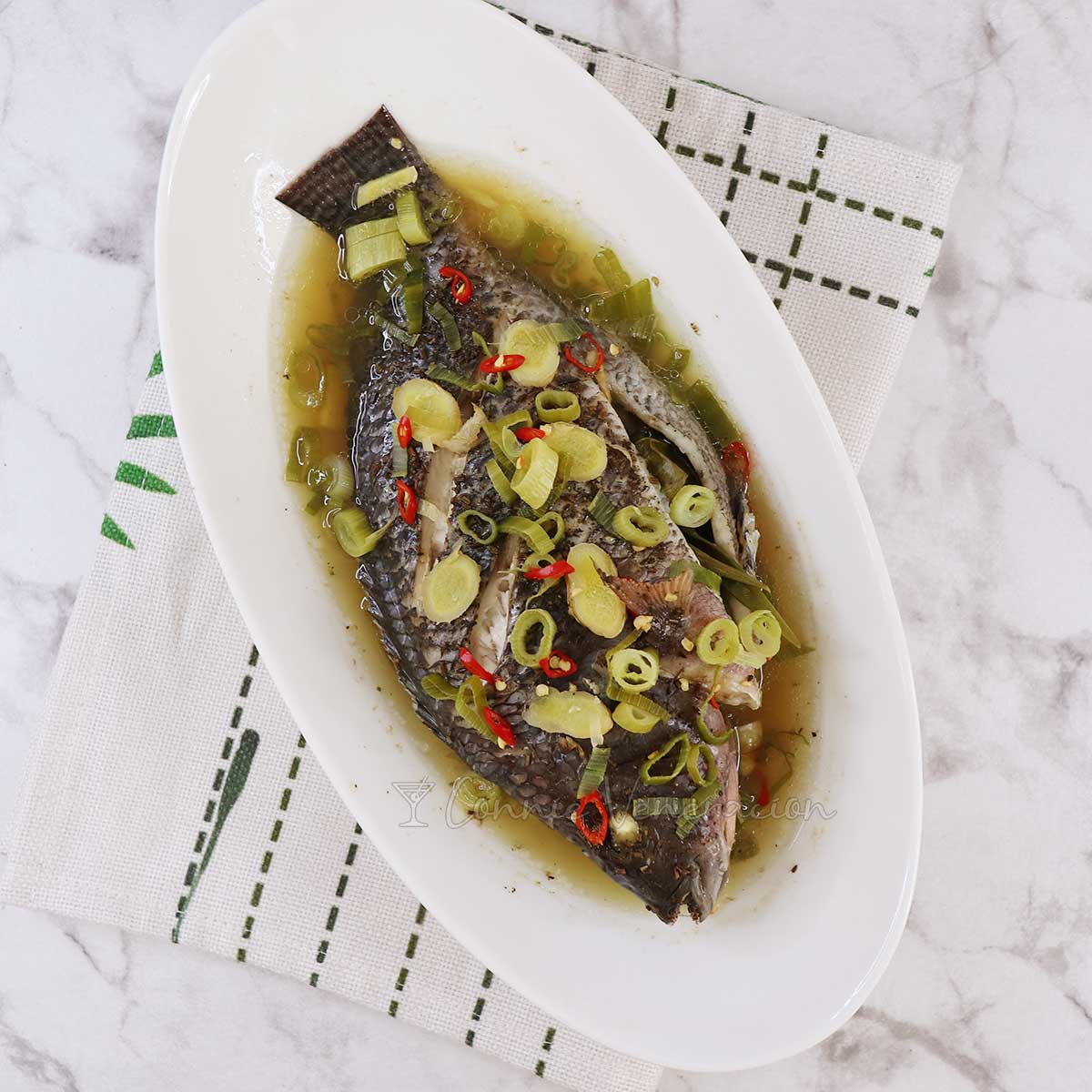 Steamed whole tilapia with ginger, scallions and chilies