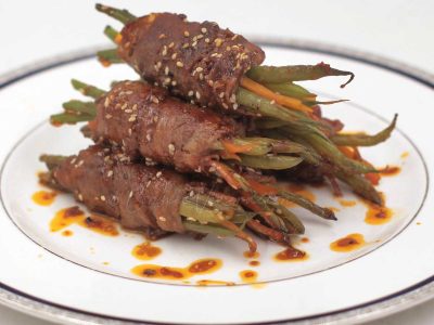 Beef-wrapped green beans with soy honey Sriracha sauce