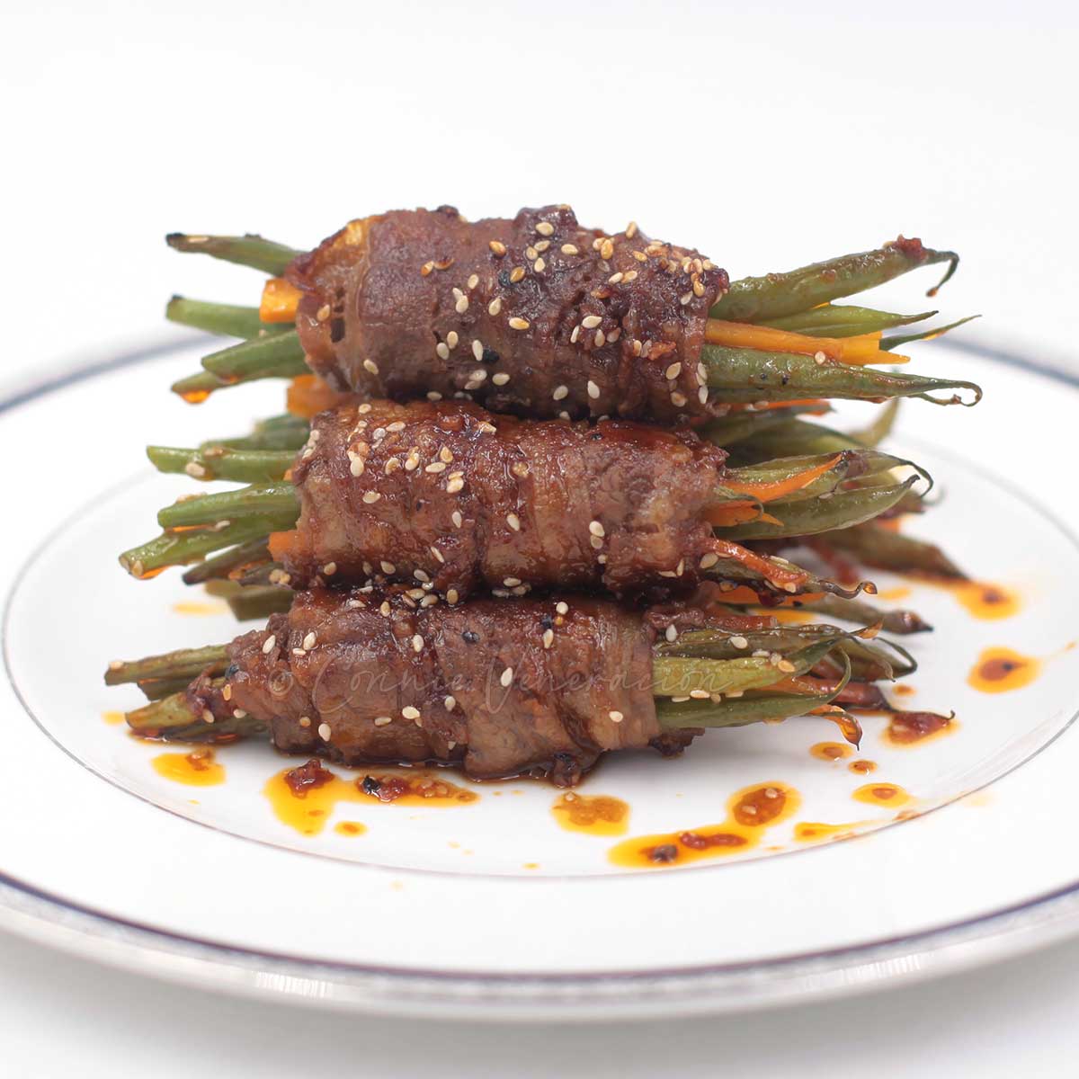 Beef-wrapped green beans with soy honey Sriracha sauce