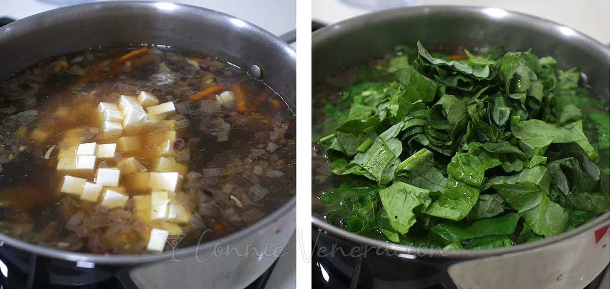 Adding tofu cubes and Chinese broccoli leaves to soup in pan