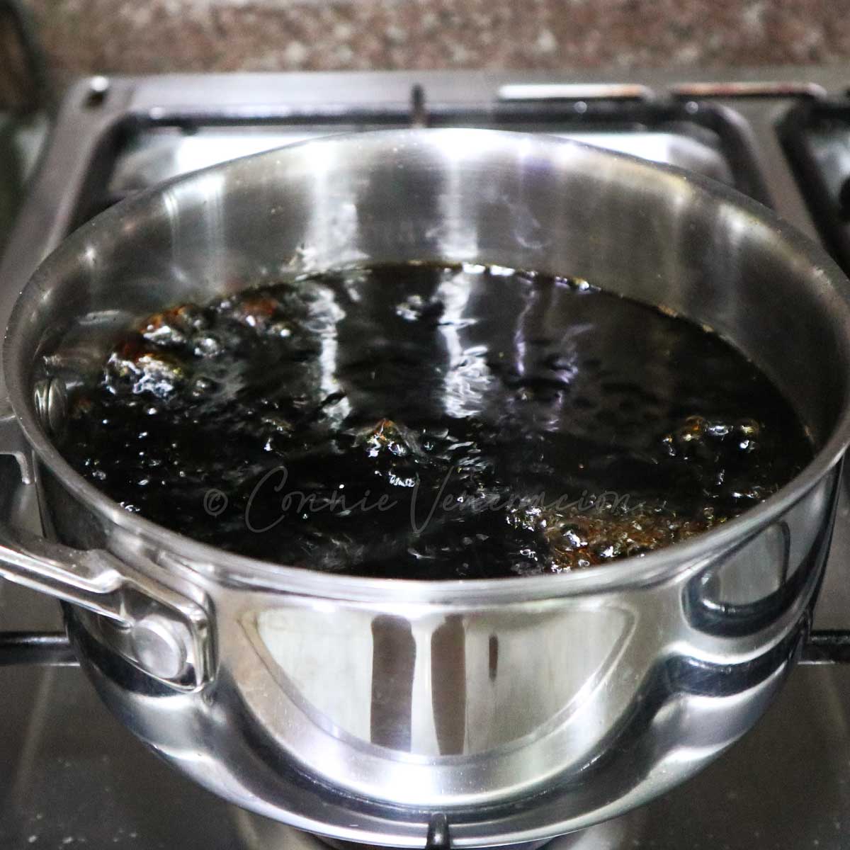 Reducing teriyaki sauce in pot on stovetop