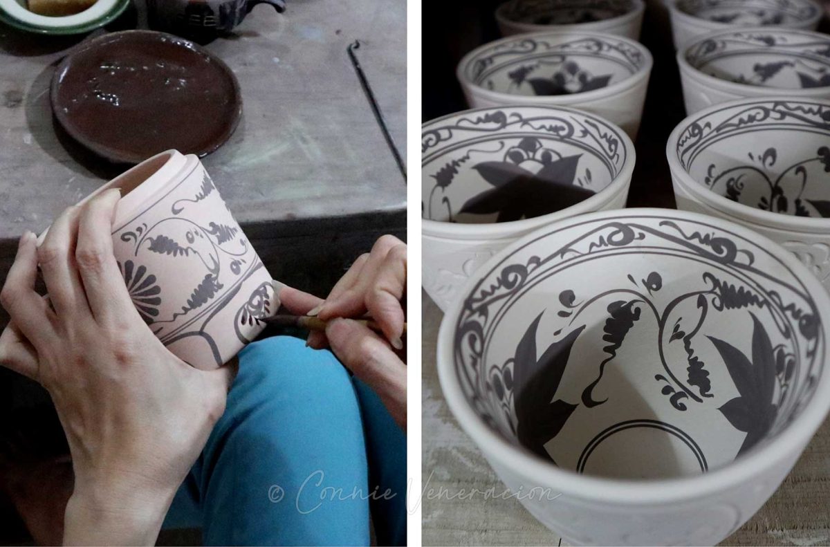 An artist hand paints a ceramic cup in Bat Trang, Vietnam