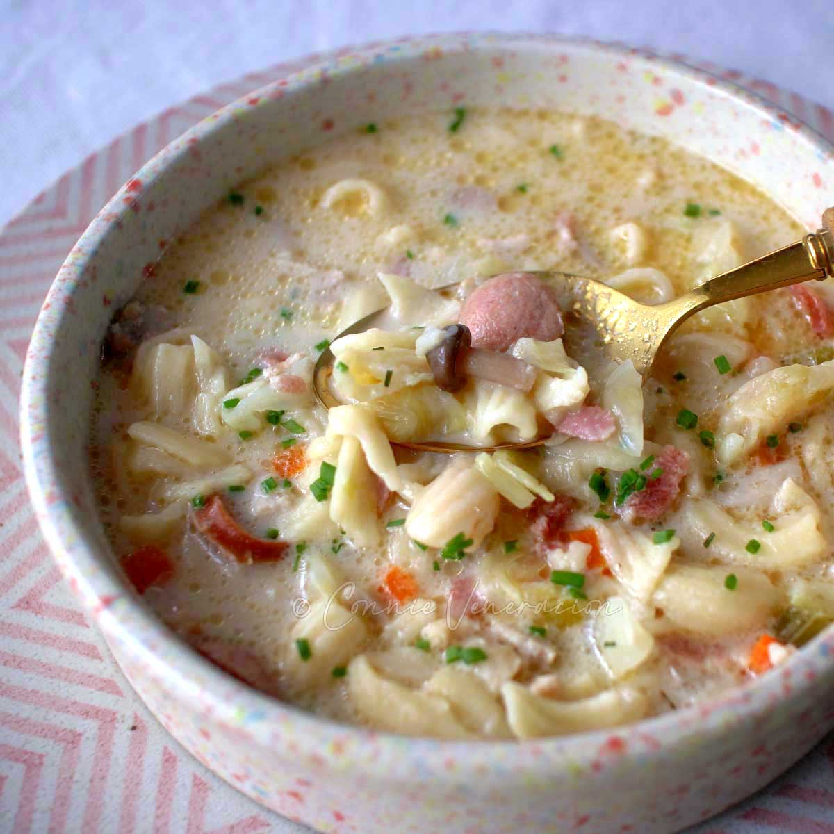 Creamy chicken and macaroni soup (Filipino sopas)