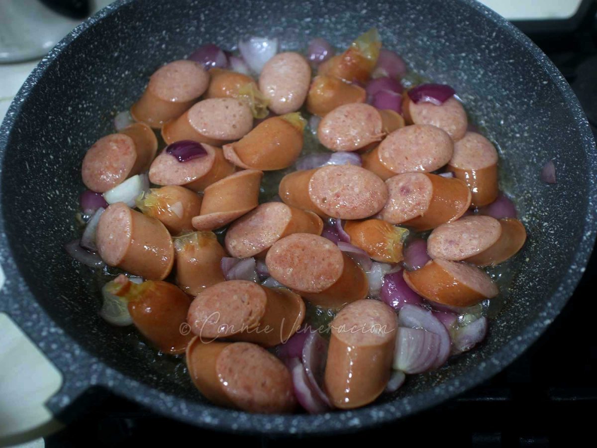 Frying sausages and onions