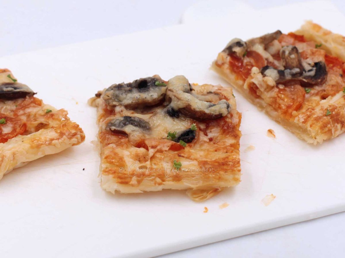Cheese and mushroom puff pastry tart cut into squares