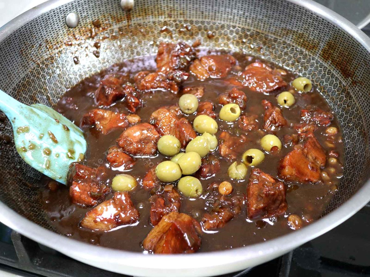 Italian-style sweet and sour pork stew (spezzatino agrodolce) with pitted olives