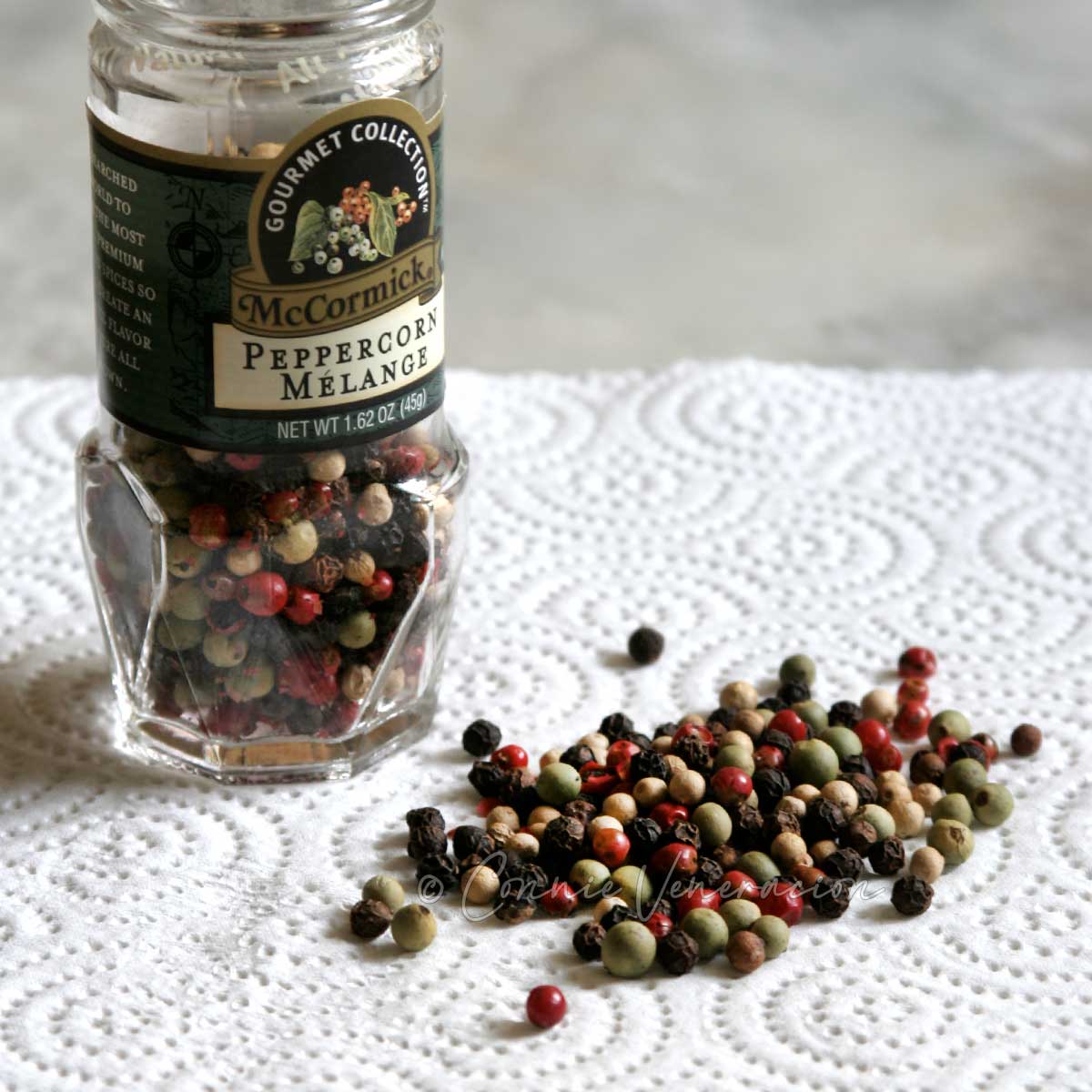 A jar of peppercorns in different colors