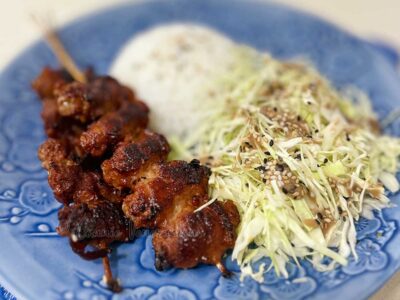 Skewered pork belly teriyaki with rice and cabbage