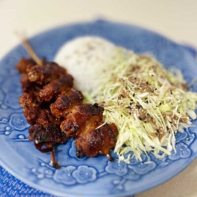 Skewered pork belly teriyaki with rice and cabbage