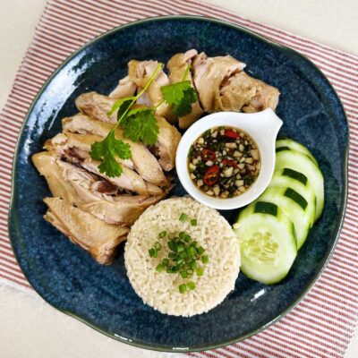 Lemongrass pandan chicken with rice, dipping sauce and cucumber slices