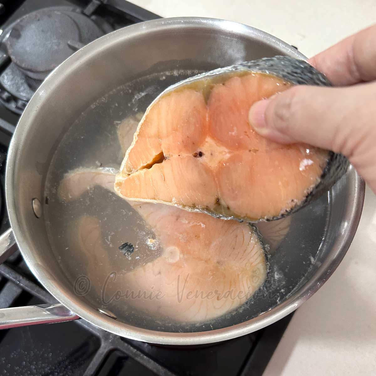 Simmering salmon in water