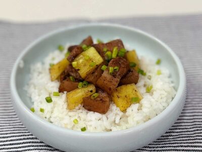 Balsamic pork and pineapple adobo garnished with scallions