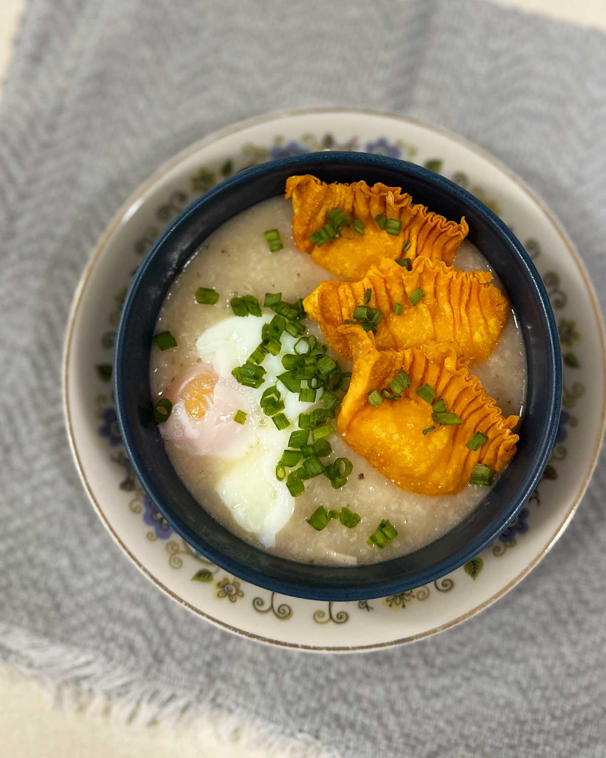Congee with onsen egg, fried shrimp dumplings and scallions