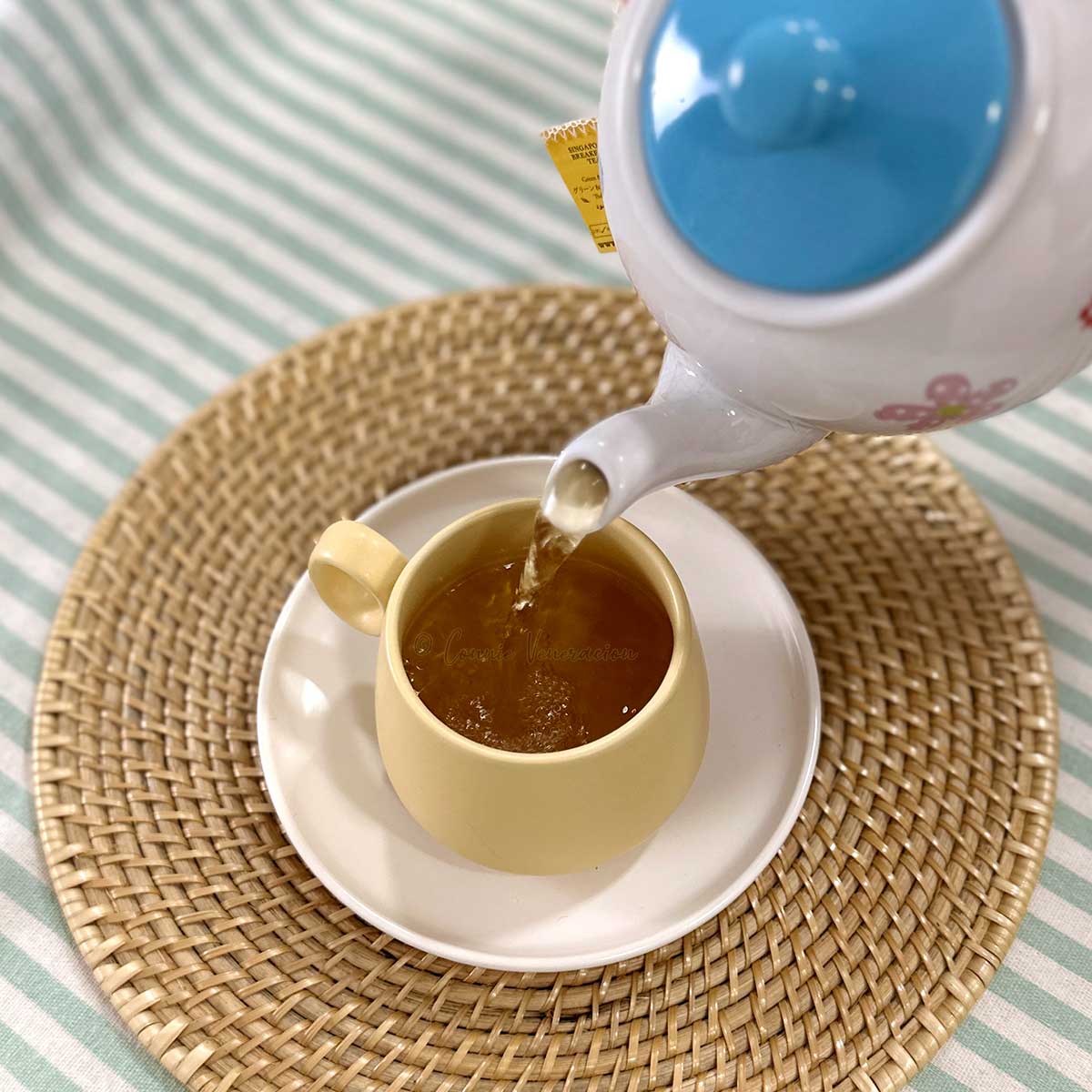 Pouring tea into cup