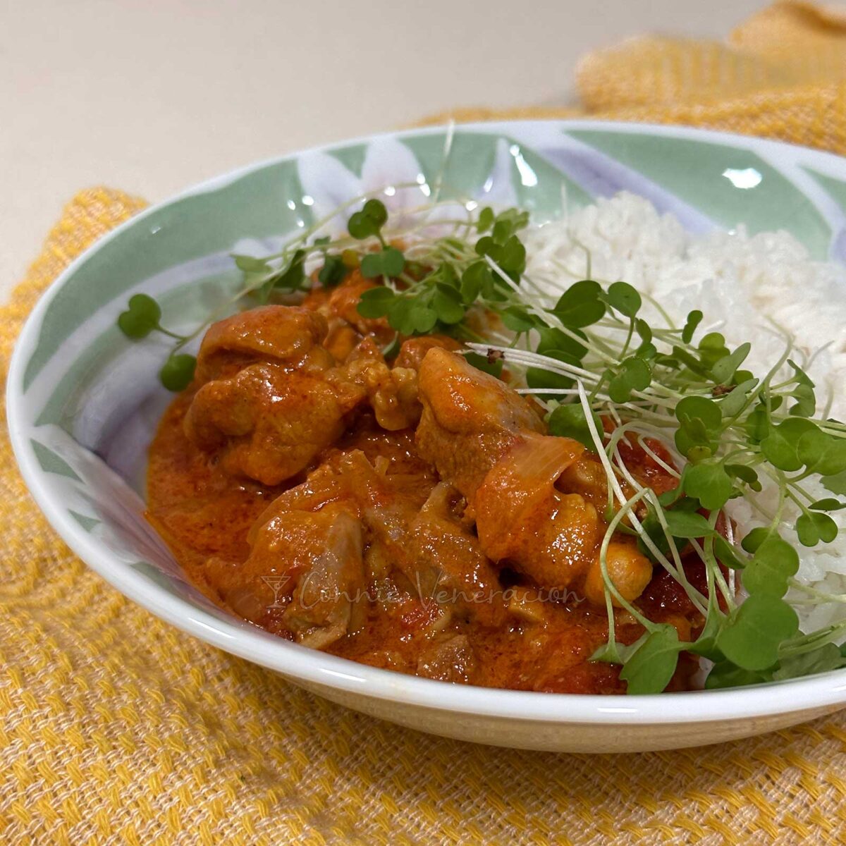 chicken tomato curry with microgreens and rice