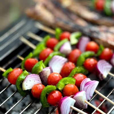 On the grill: skewered cherry tomatoes, onion, wedges and diced bell peppers