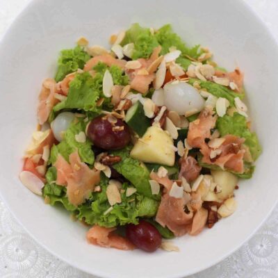 Smoked salmon salad with fruits and nuts